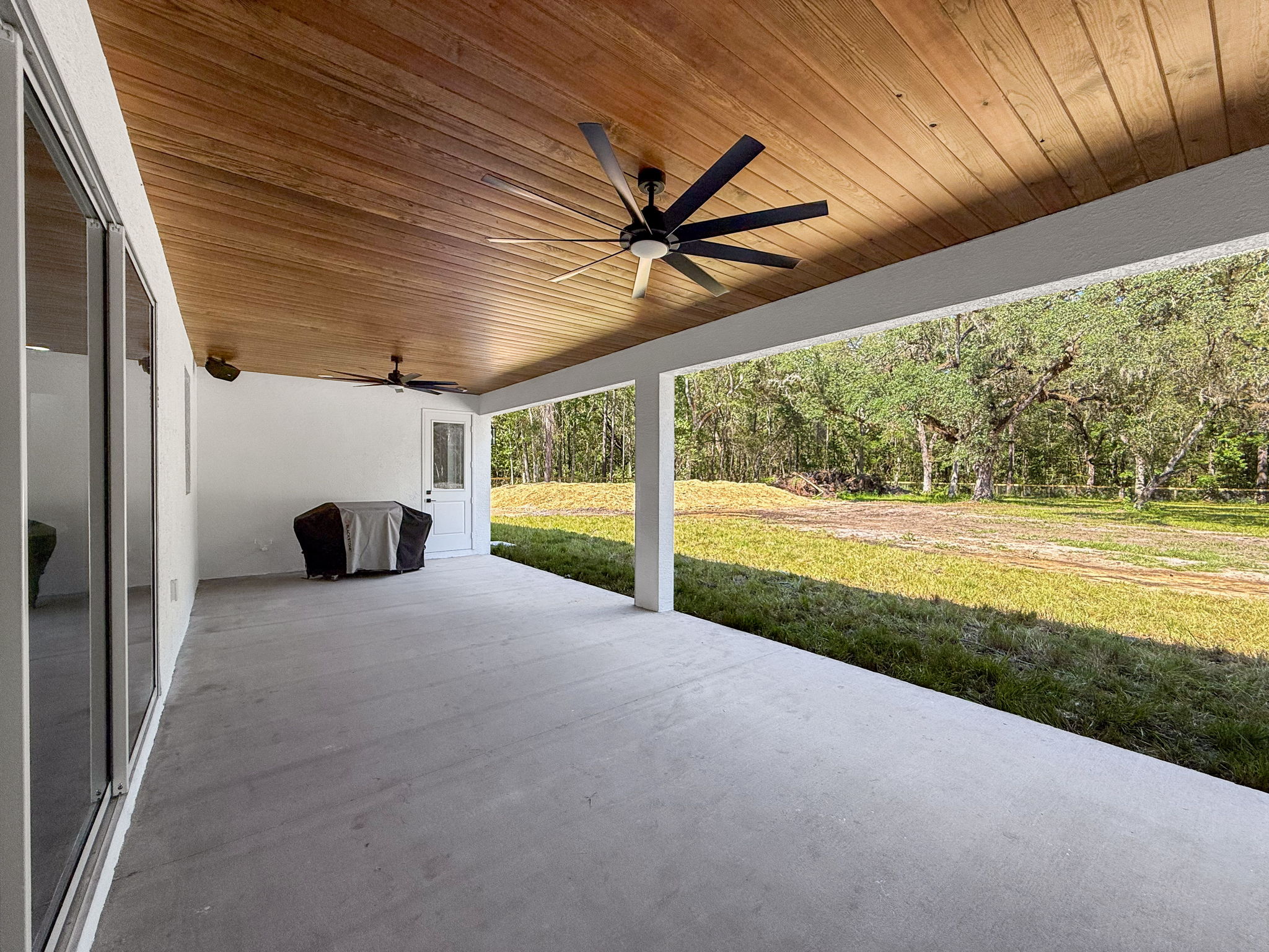 Covered back porch of the completed Brooksville custom farmhouse